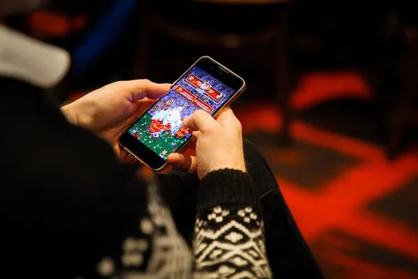 A man focused on his laptop with live stats in the background, highlighting the dedicated sports and gaming features of the JEETA mobile app.